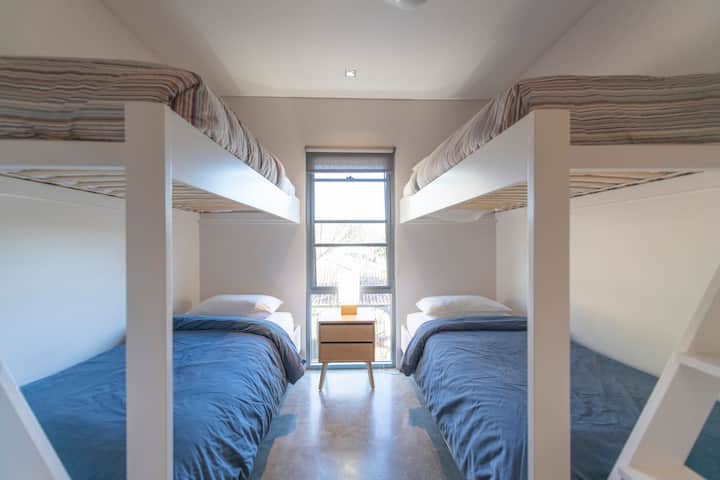 Bunk room with long single bunks