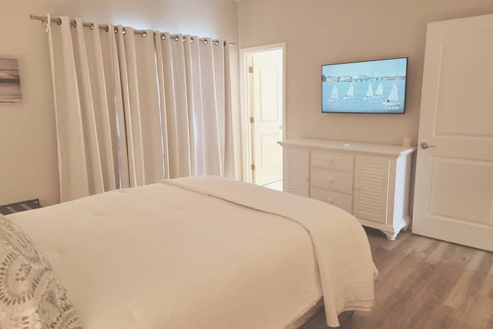TheGuest Bedroom is located on the first level and features its own adjoining full bathroom, Smart TV, and room darkening drapes.