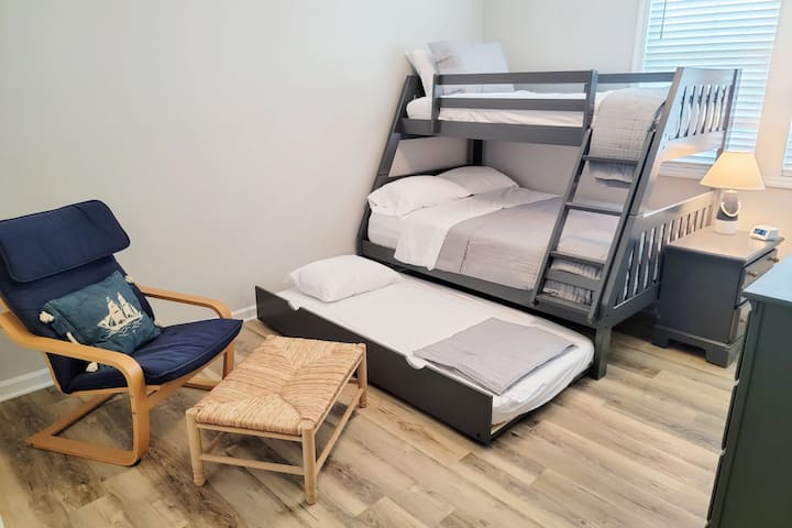 The 3rd level bunk room features a twin over full bunk bed with a pullout twin trundle and its own bathroom, closet, and Smart TV. 