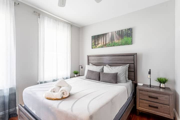 This stylish home you'll find Comfort and style come together in this spacious bedroom, with a functional desk and a TV for your entertainment
