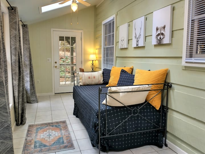 The light and airy sun room, just off the kitchen, offers another hang out space separate from the main living area.