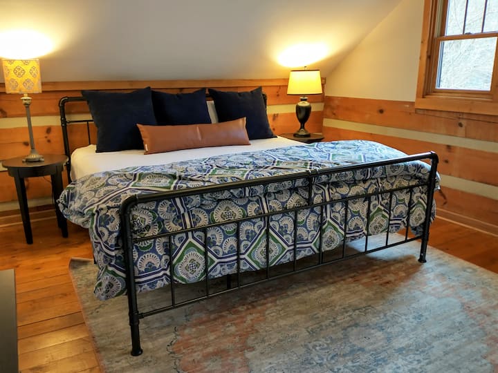 Family suite bedroom upstairs features a plush king bed.