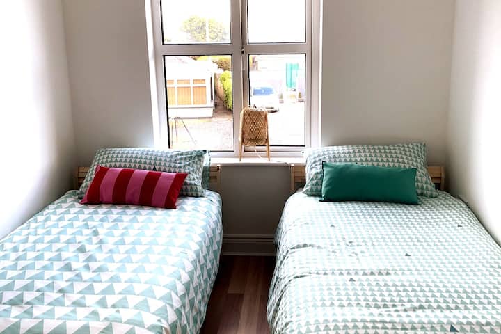 The second bedroom has two single beds and lots of natural light all morning. 