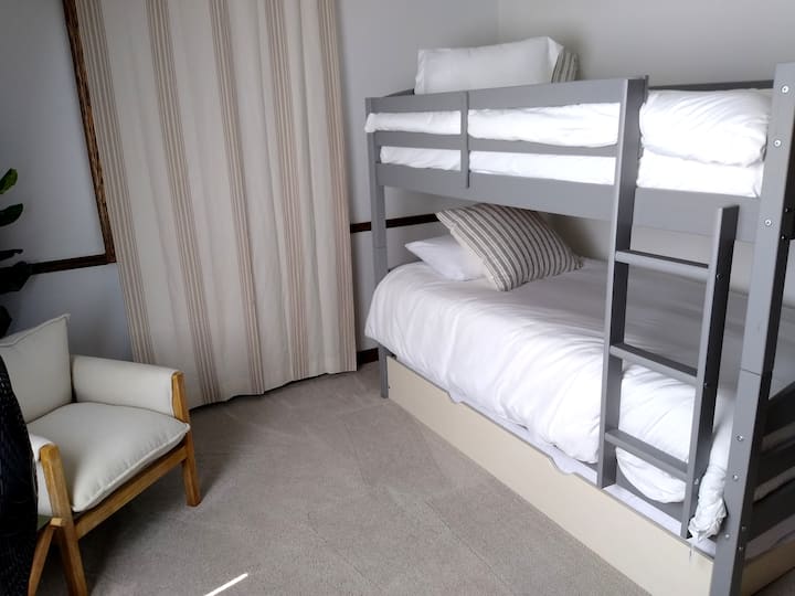 Upstairs twin bunk bed, plus third hidden day bed underneath.