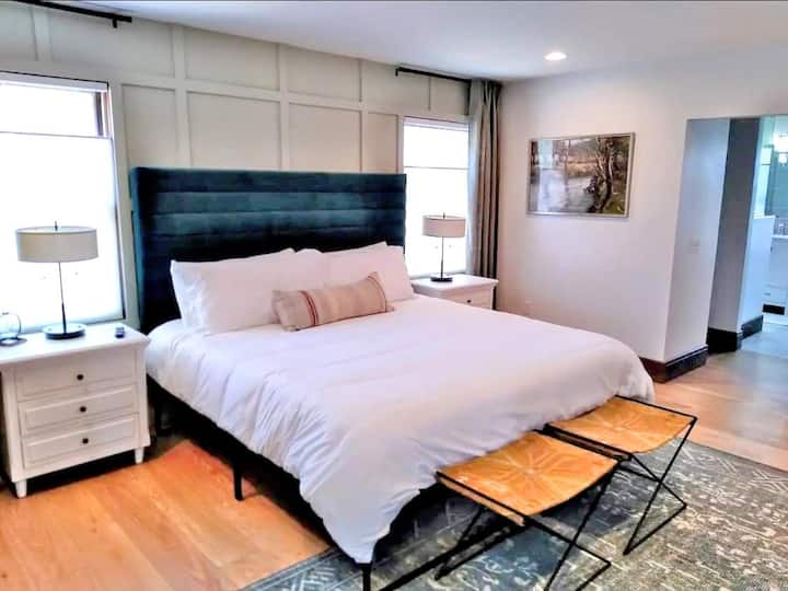 Spacious master suite on the main floor, with private fireplace, TV, and sunroom / backyard access.