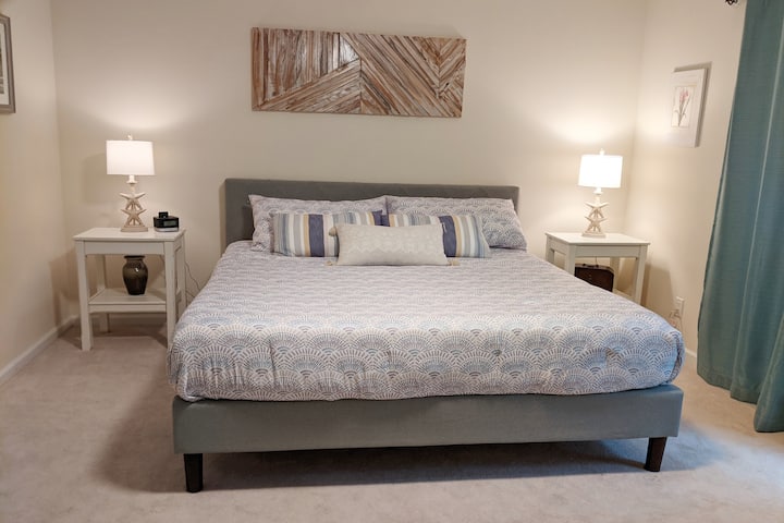 Primary bedroom with king bed and walk-out to back  yard.  Room darkening curtains. 