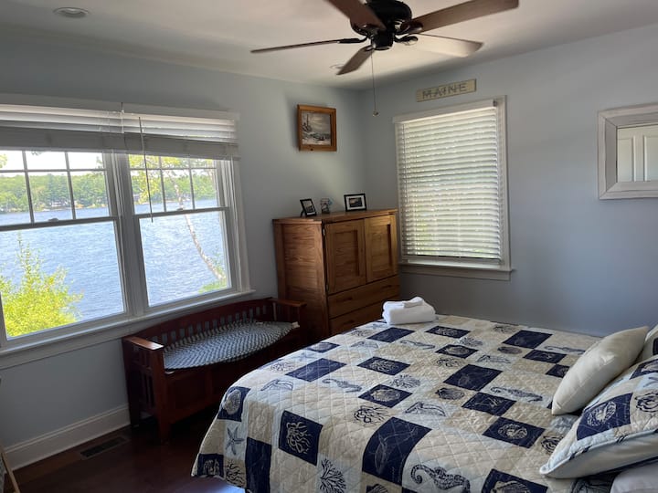 Single queen bed downstairs with a view of the water