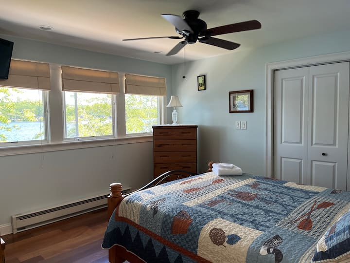Master bedroom upstairs with water view and attached bathroom