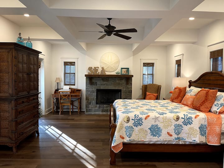 Master Bedroom with King bed, fireplace, desk, TV and large closet with ensuite bathroom and private screened lanai.