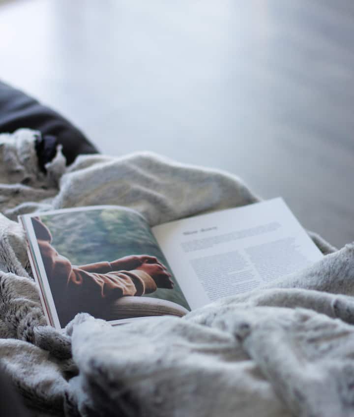Cozy up on the couch under a blanket with a good book