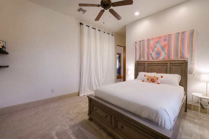 Първата спалня за гости с удобно двойно легло и красиви гледки към гигантското сагуаро през прозореца.
