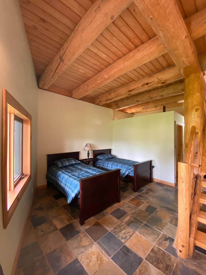 Two twin beds with windows overlooking the lake