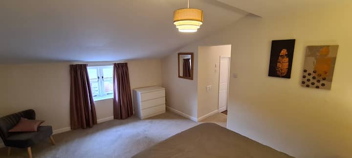 Large bedroom with king size bed and plenty of storage.