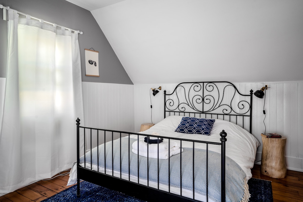 The Camp Room.  Wake up to the birds chirping and the sun streaming in through the trees. (or pull down the black out blinds and sleep in as late as you like!). Very comfy Queen size bed and ample closet space with full length mirrored doors.