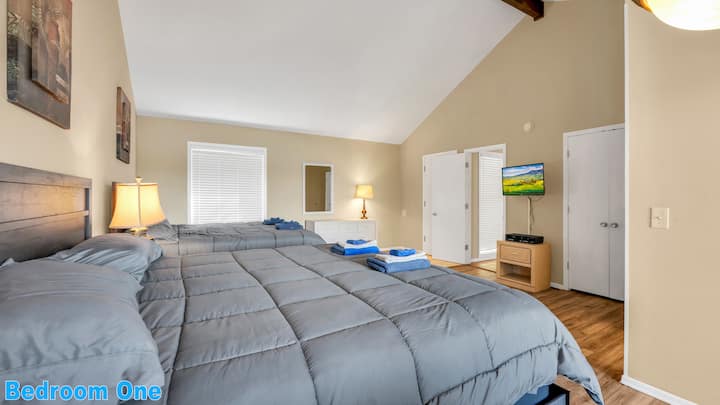 Main Level Bedroom #1: Double King-size beds with a private full bathroom, pub table, private balcony, and cable TV.