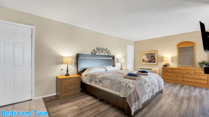 Main Level Bedroom #2: Single King-size bed with a private full bathroom, pub table, private balcony, and cable TV.