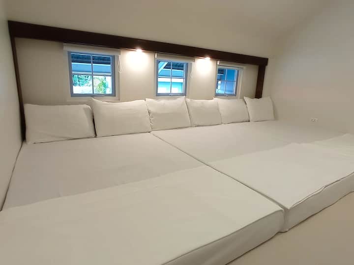 Bedroom 3 - Air-con room sleeps 8 Adults. Second level room with 1 King bed (sleeps 2 Adults) and 3 double beds (Sleeps 6 Adults). 