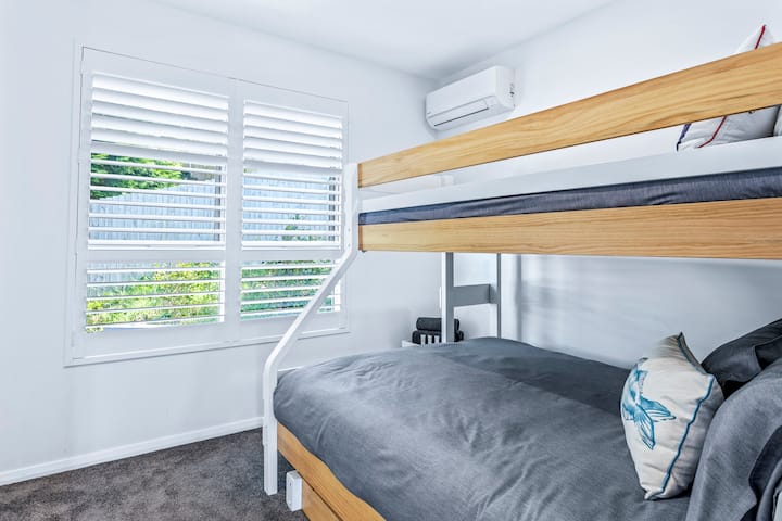 Third bedroom.  Reverse cycle airconditioning and lovely plantation shutters.  Bunk beds consist of
1 x Queen, 1 x King Single (top) and a trundle bed which would suit a 2-7 year old child. 
Generous built in wardrobe in the room also