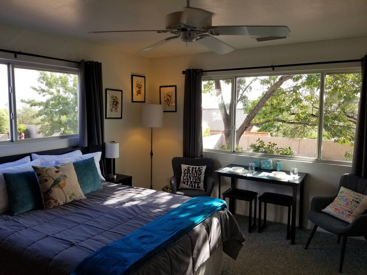 Spacious bedroom with a breakfast table.