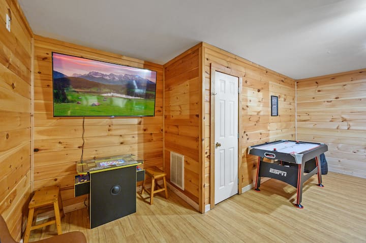 Game room with an air hockey table, arcade game, and large 65" TV. Great for enjoying a day/night in.