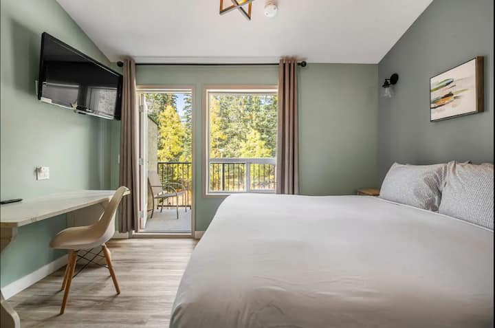 La chambre principale dispose d'un lit king size avec grand balcon et vue sur la montagne et le parc.