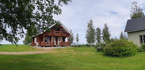 Cozy log cabin in a beautiful hillside landscape