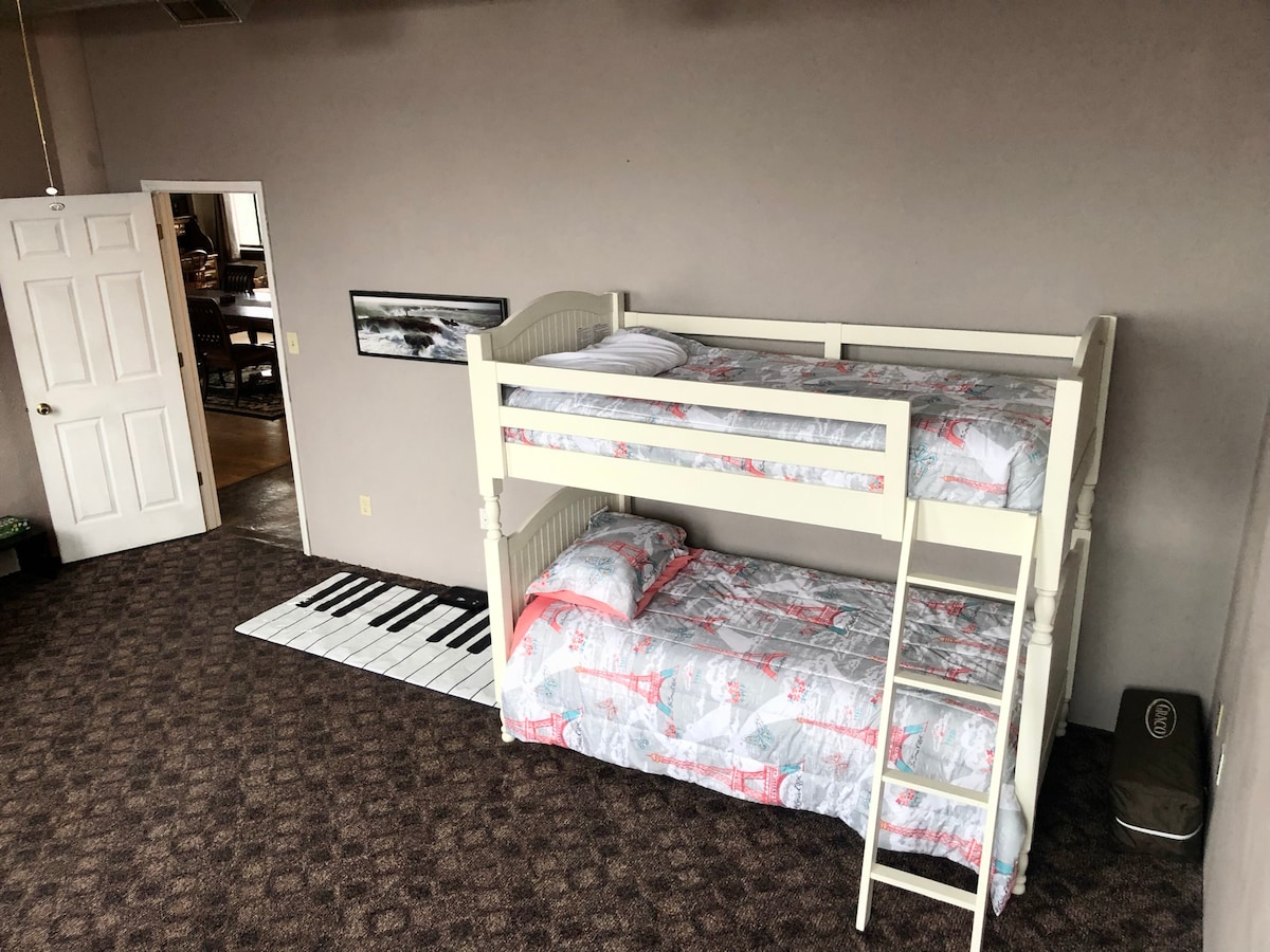 The kids room includes bunk beds and a futon.