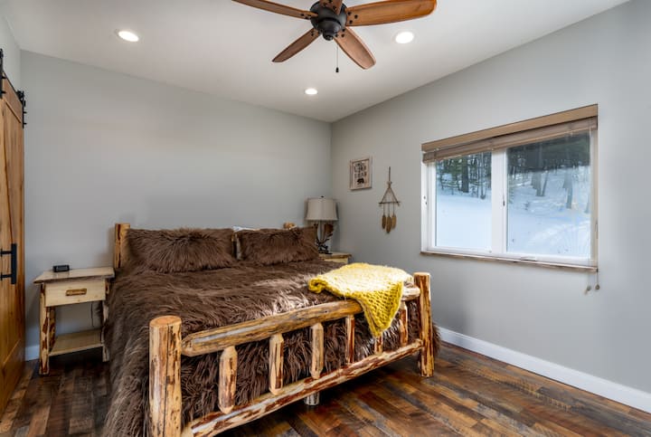 Enjoy a comfy nights sleep in the king-size master bedroom with some Montana log home style and wake up to great views of the forest and mountain peaks.