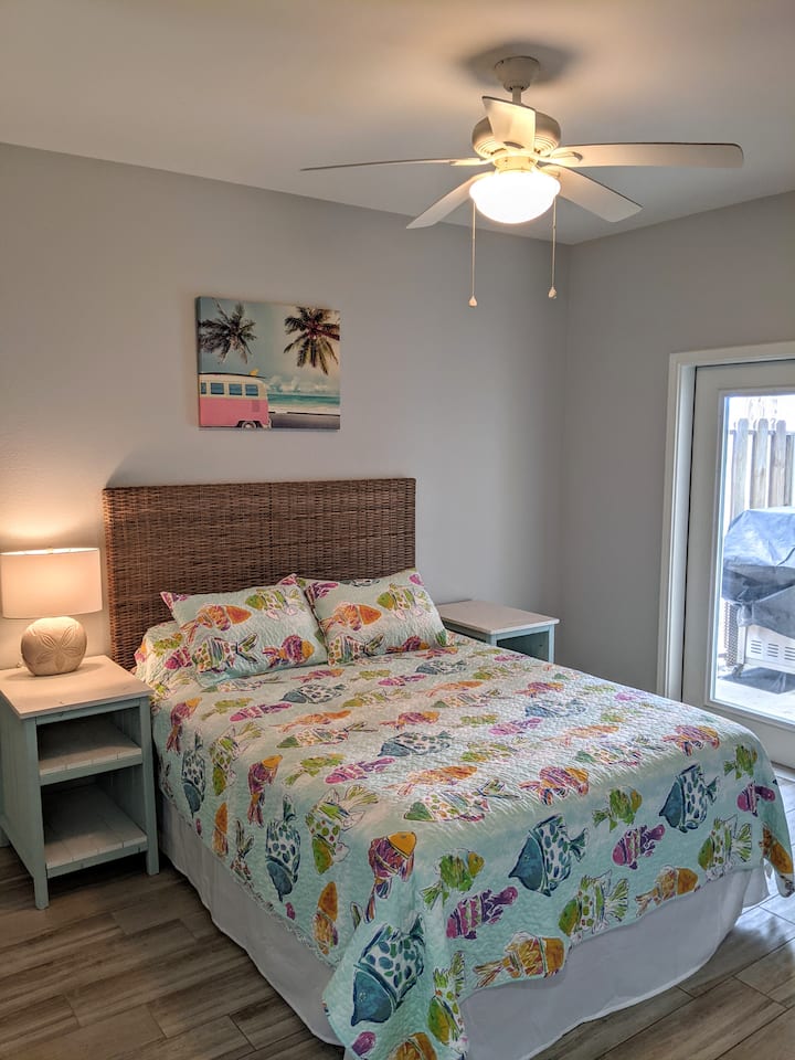 1st level bedroom with queen and access to patio