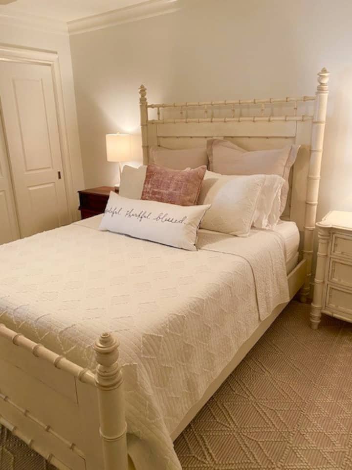 Queen bed with mounted TV in bedroom 