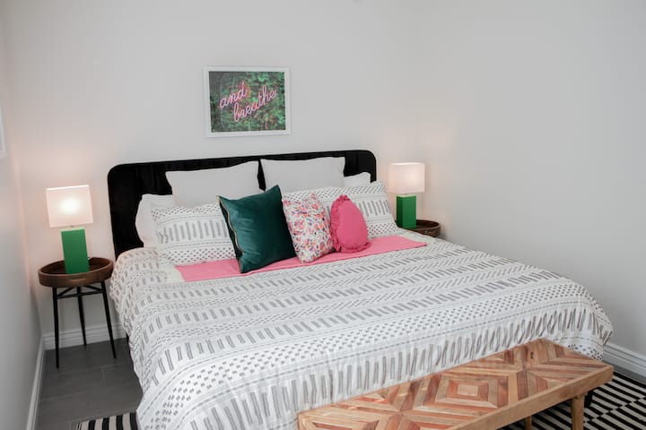 Bedroom number 3 - the Black Velvet room - another king sized bed taking center stage among a splash of color with the bedside lights and the stylish pillows