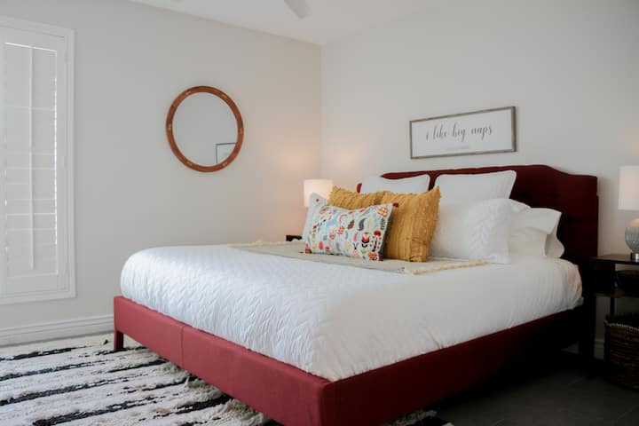 Moving into bedroom number 2 - the Red Room - with a stunning king sized bed and soft linens. Get ready to transport yourself into a dream world as you fall back onto your bed after a fun day out exploring