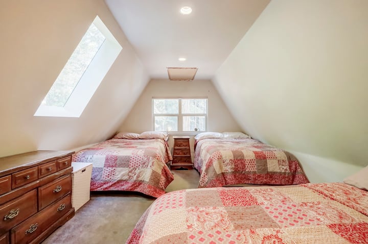 upstairs bedroom to the right of the stairs - two full beds and one queen.   no door to room or closet - it is open to the small hallway at the top of the stairs