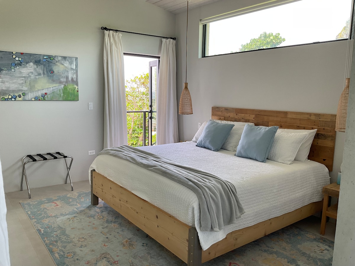 Blue room. King ensuite, opens to spiral staircase directly onto the beach sand.