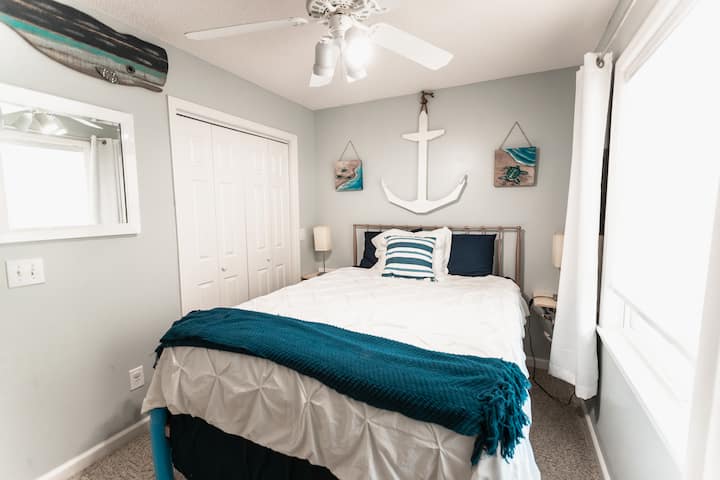 Beach themed Bedroom has a queen bed, closet space.  This room is the smallest of the 3 rooms. 