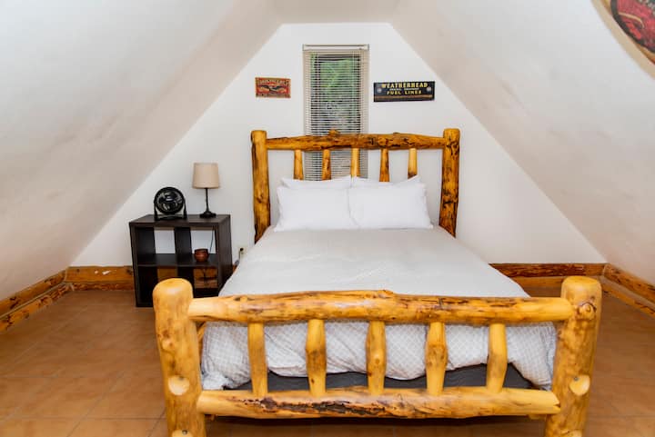 2nd bedroom with custom handcrafted wooden queen size bed.