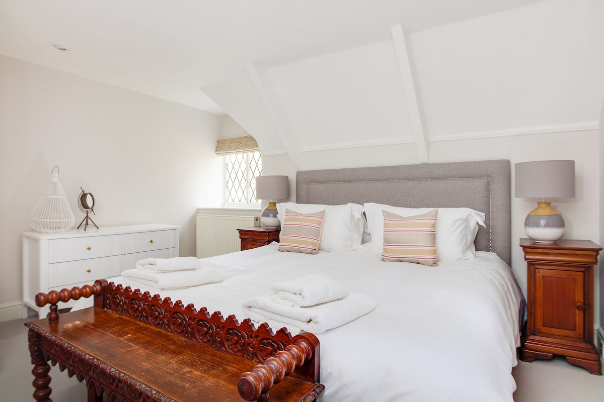 Super king bedroom with generous wardrobe storage and beach glimpses.