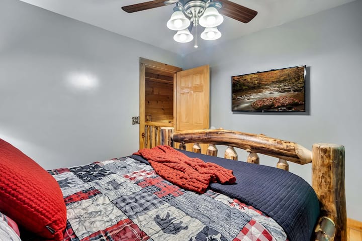 The second bedroom has a queen size Alpine Log bed and a 43" streaming TV