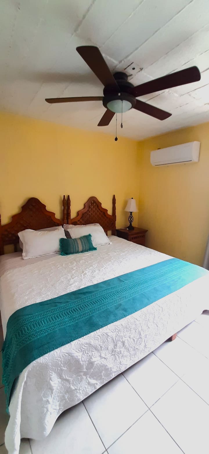 Room 2 with A/C, fan, blackout curtains, closet, smart TV and workspace