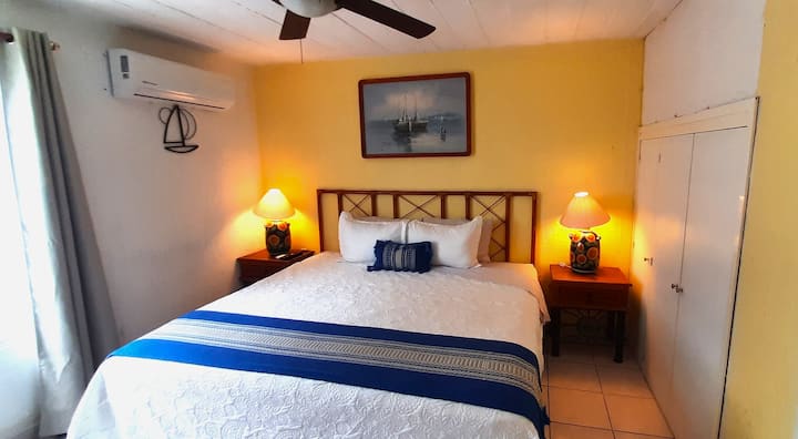 Room 1 with A/C, fan, blackout curtains, closet, smart TV and workspace