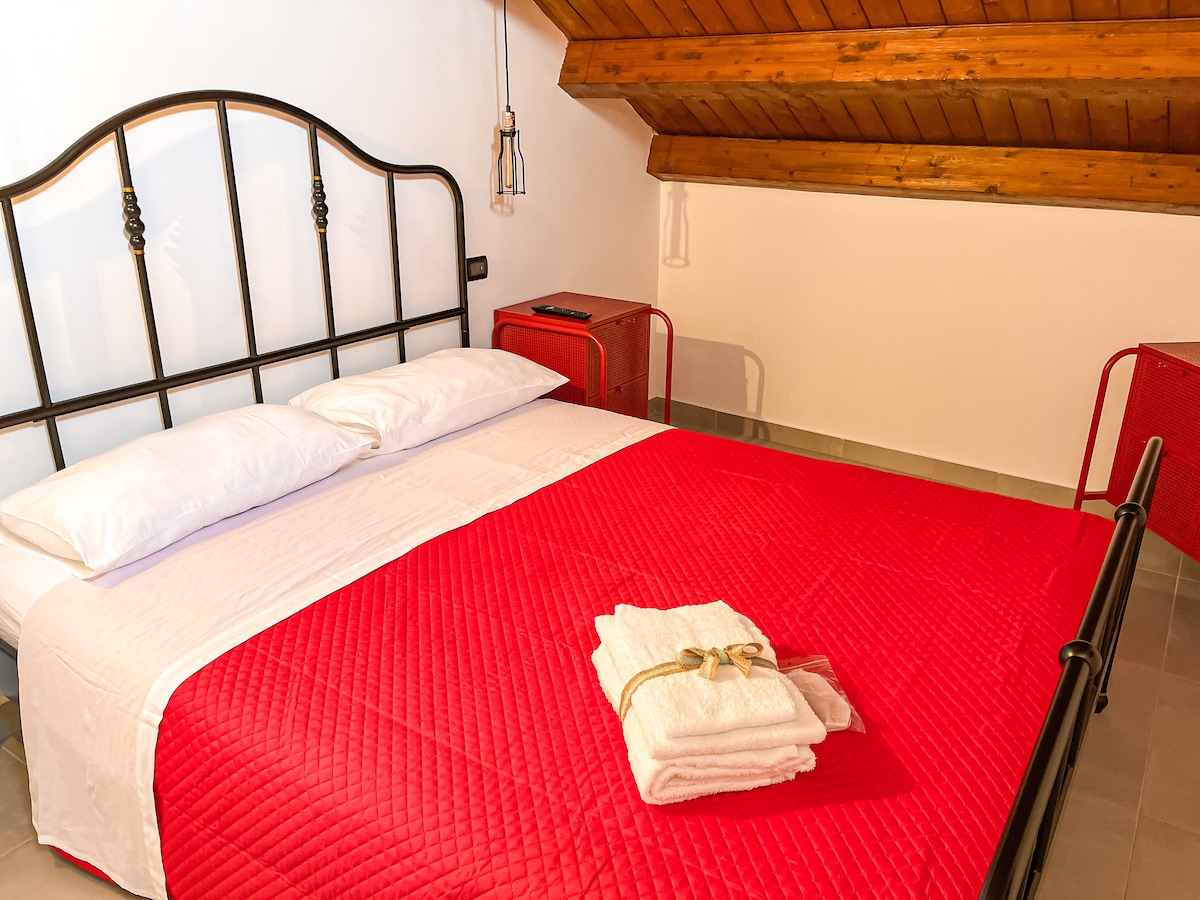 Bedroom 1 with Queen size bed, air conditioner, 32"Smart TV, power outlets near the bed and towel sets included.