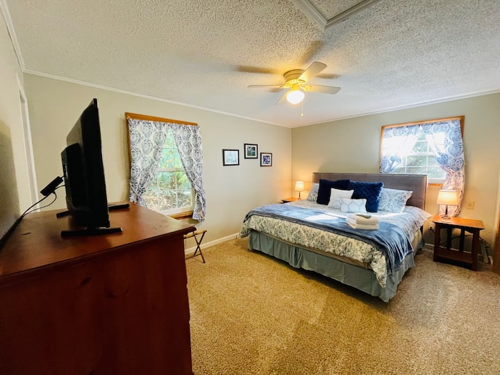 Main Bedroom - New King Bed and plenty of storage for your belongings with chest and closet.  Smart tv. En suite full bathroom.