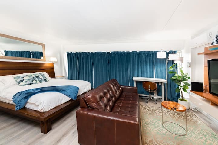 Our condo is a legal one bedroom condo however the wall separating the bedroom from the living room to create an open-concept living space. The genuine leather pull-out sofa bed can accommodate up to 4 guests. 