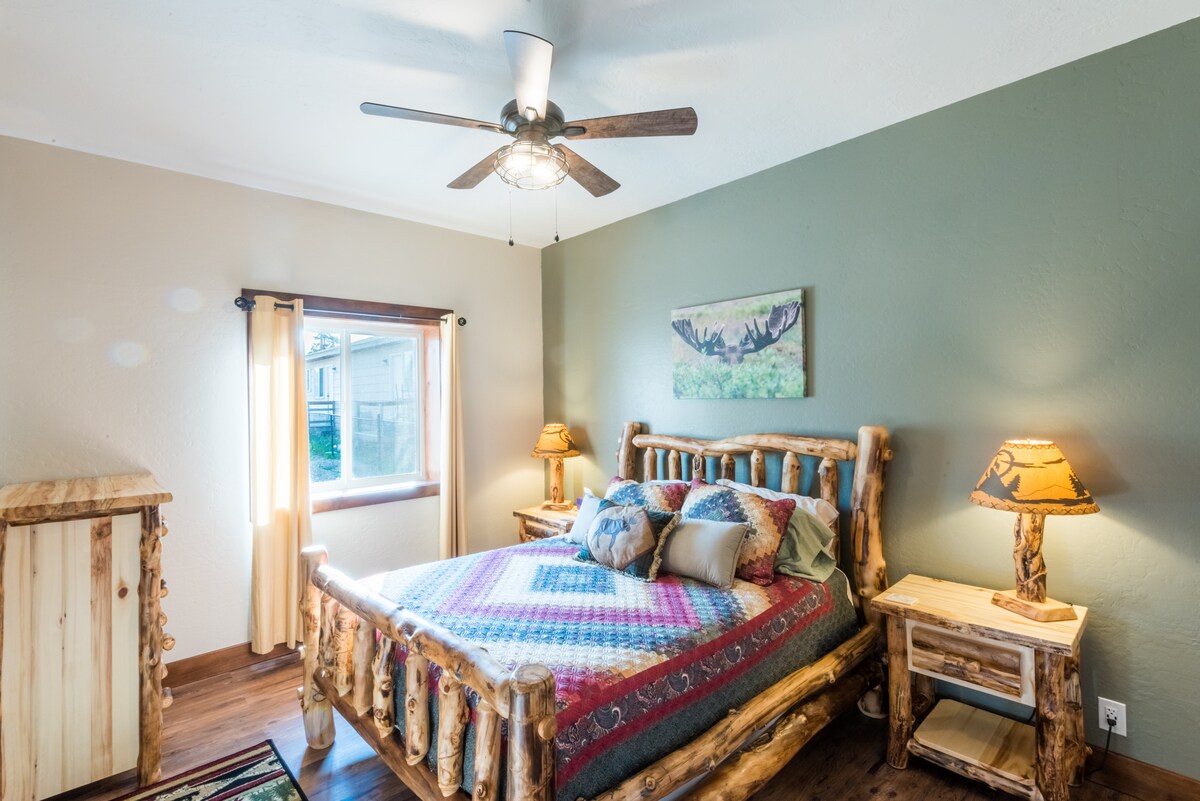 Moose themed queen room with luxury linens.