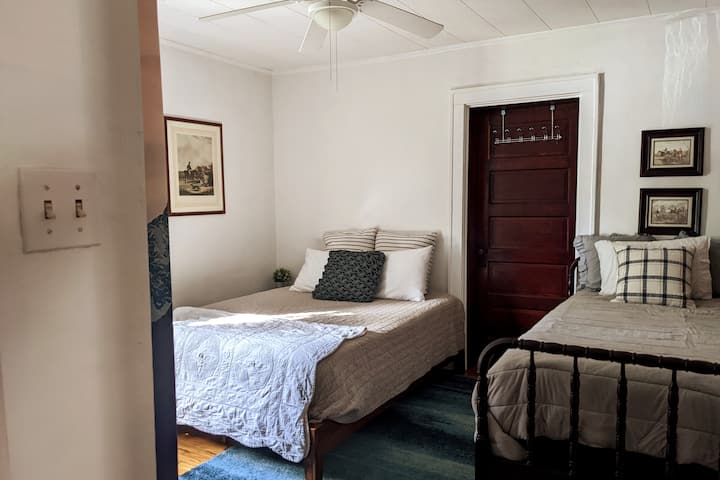 Bedroom #2 has a queen bed, twin bed, and desk for remote work.