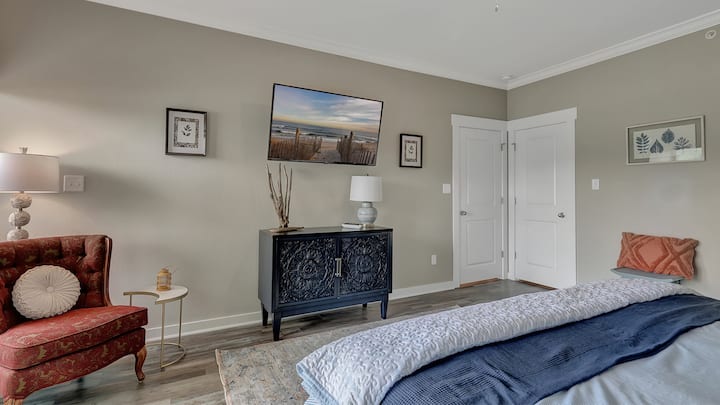 Primary bedroom with 50" smart tv.