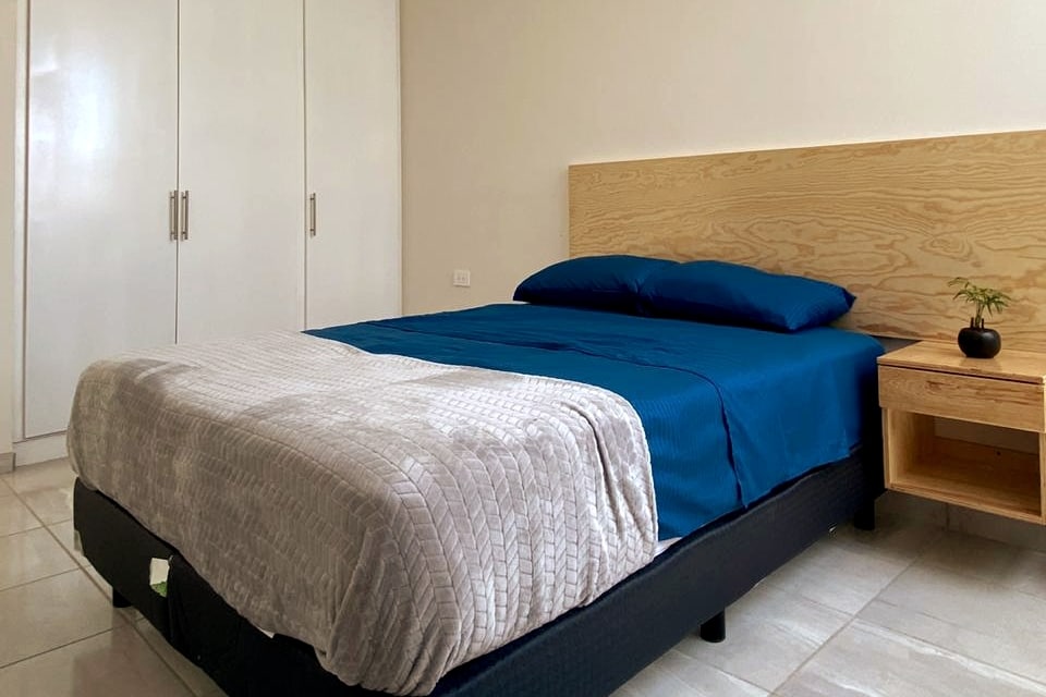 Secondary bedroom with large closet and natural light. View 1