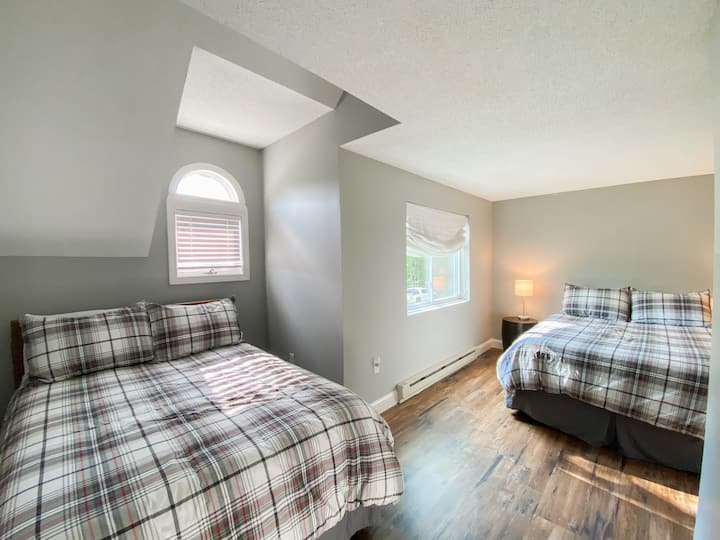 A view of the 2nd bedroom on the second floor with one queen and one full size bed with custom blackout shades to ensure a good night's rest!