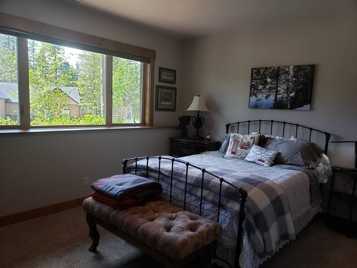Our Glacier themed guest room.  Queen size bed.  Side tables have lamps and cords with USB outlets.
The room has a chair and bench for guest use.  The closet has space for hanging some items with provided hangers. There is a mini fridge in the room.