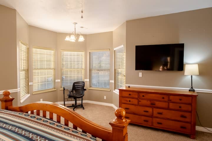Large master bedroom upstairs with king bed, desk with a view and 50" TV.